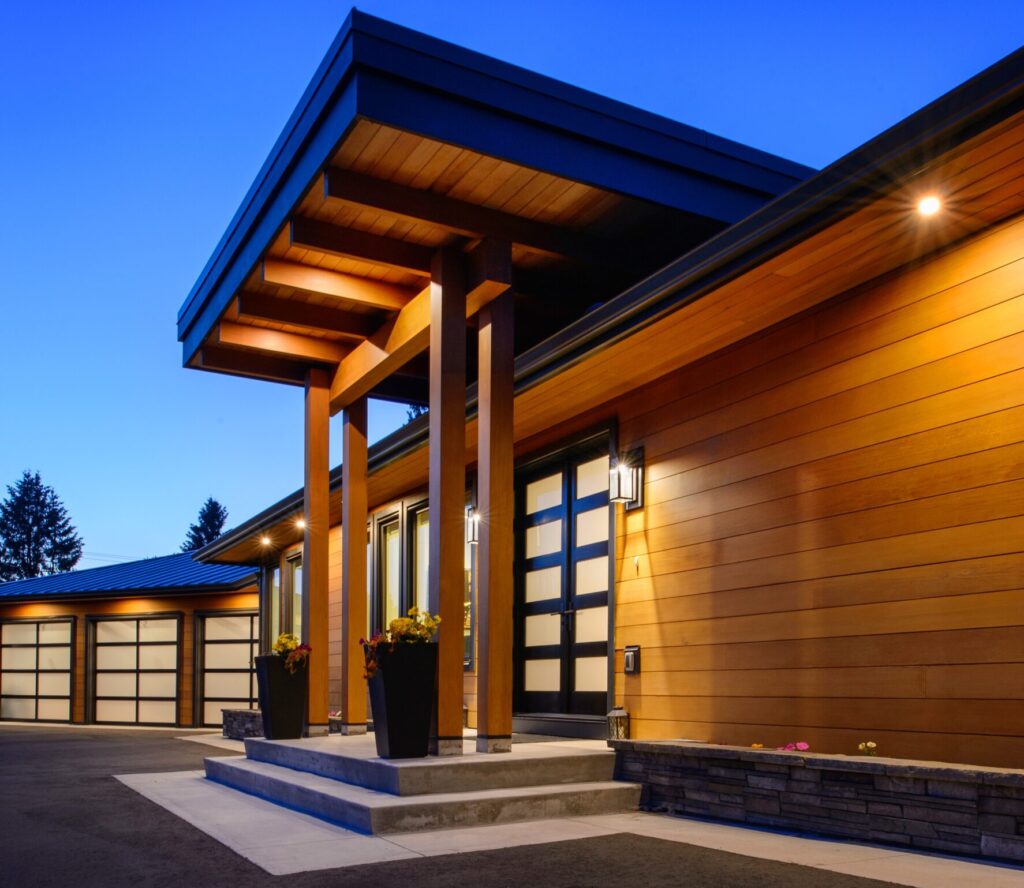 Side photo of laneway home with navy blue paneling. 