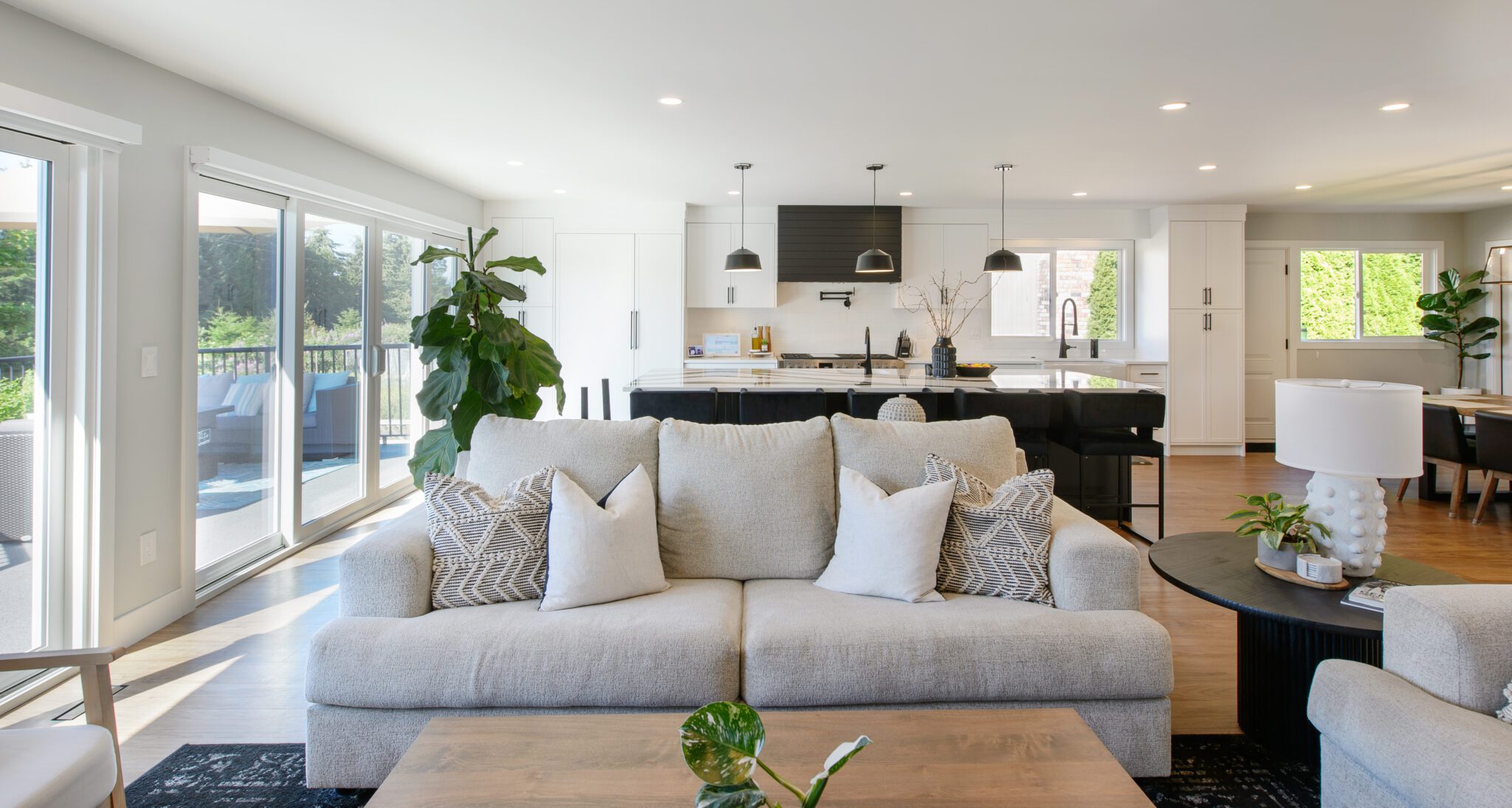 Beige couch with view of kitchen in the background.