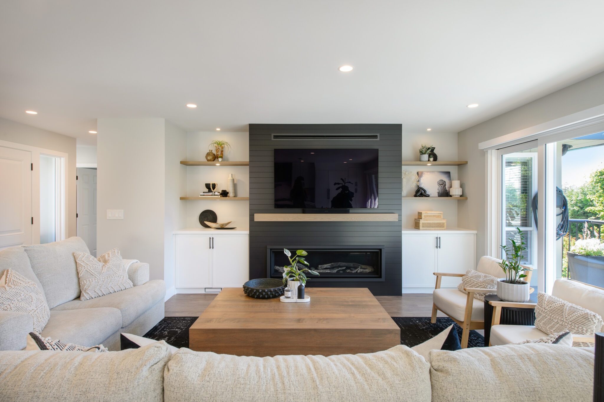 View from back of the couch, with fireplace and tv perched atop a black background.