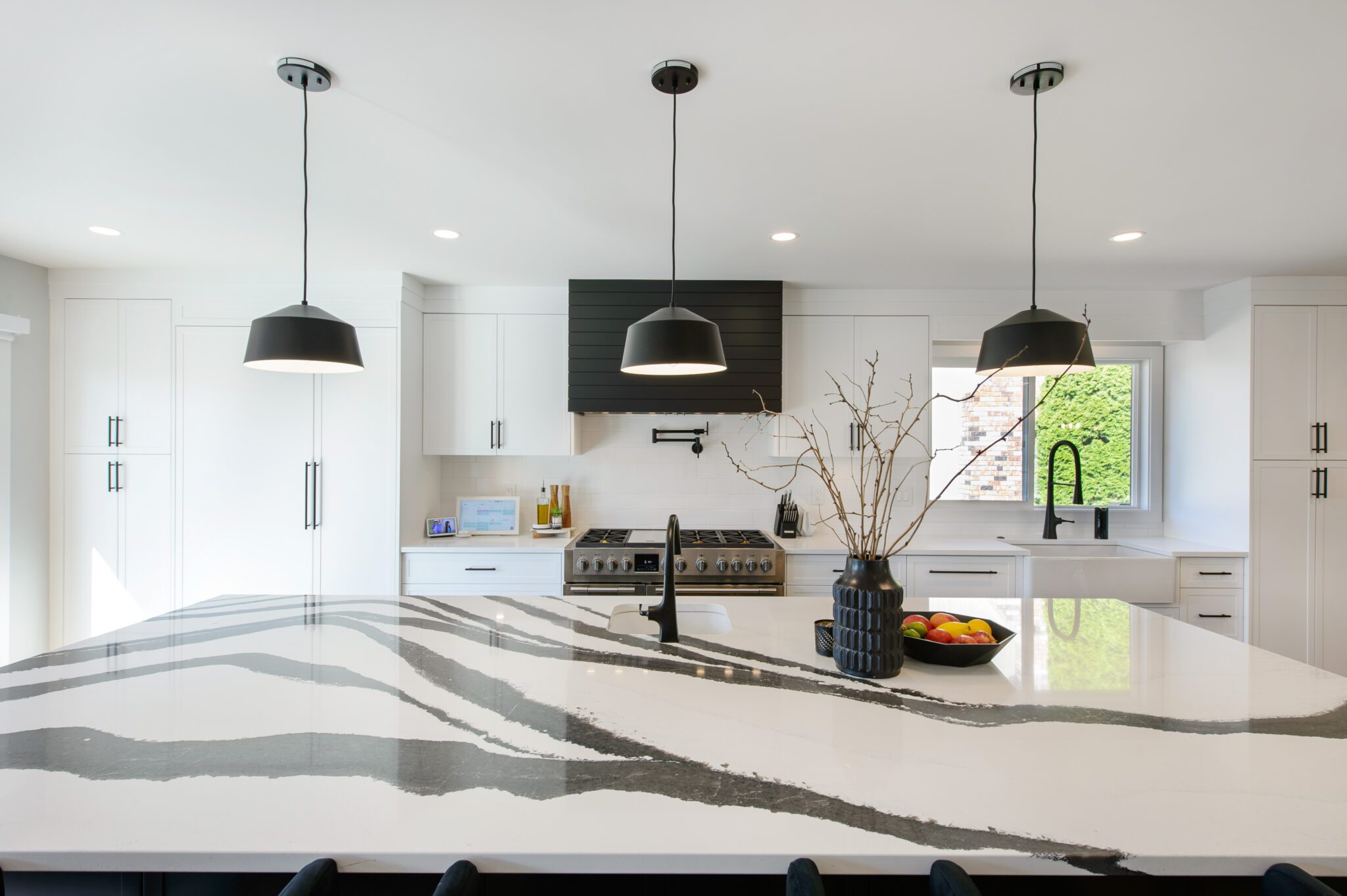 View of quartz countertop with a zebra-like black and white marbled, glossy finish.